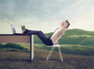 Business Man Relaxing in Field with Desk