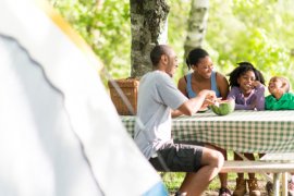 Family eating lunch while camping.