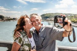 Older couple taking self portraits - Cultura/Dan Brownsword/Riser/Getty Images