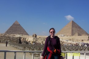 standing in front of the egyptian pyramids at Giza and the sphinx