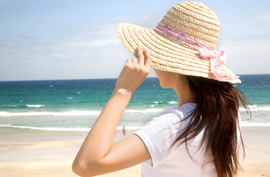 woman beach ocean hat summer travel relax